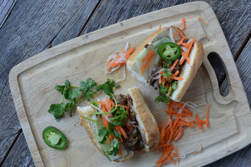 Vietnamese Grilled Pork Banh Mi Sandwich on Rustic Wood Backgrou - 79038591