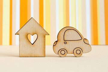 Wooden house with hole in the form of heart with car icon on ora