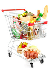Shopping cart full with various groceries isolated on white