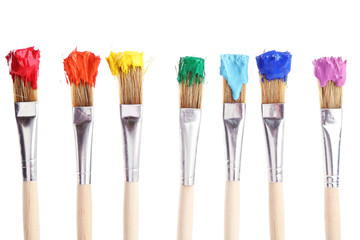 Brushes with colorful paints, isolated on white