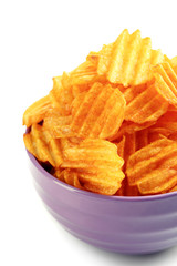 Delicious potato chips in bowl isolated on white