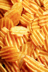 Delicious potato chips closeup background