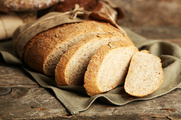 Sliced fresh bread, on old wooden table
