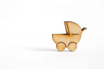 Wooden icon of baby carriage on white background