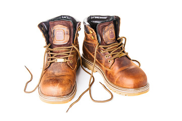 Pair of brown boots on white background