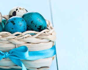 Colorful easter eggs in white basket