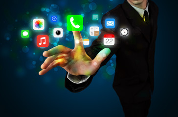 Handsome businessman pressing colorful mobile app icons with bok