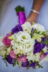 Beautiful wedding bouquet in hands of the bride