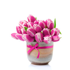 Obraz premium Beautiful pink tulips in a vase on a white background