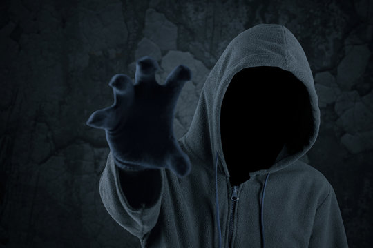 Burglar with hoody grabbing something