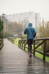 Man running in the park in a rainy day