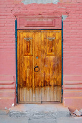Wooden door in brick wall