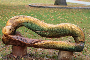 the bench in the park with the  back in the form of the snake