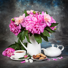 Still Peons in a jug on the table and breakfast