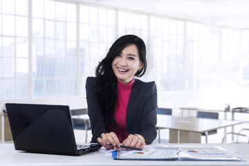 Cheerful young manager smiling at camera