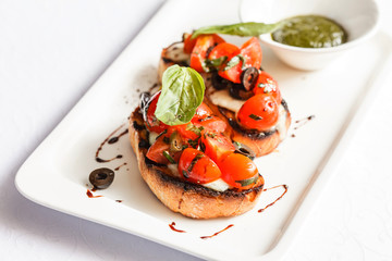 Bruschetta with tomato, mozarella and basil