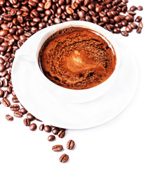 Coffee cup and saucer with  roasted coffee beans isolated on a w
