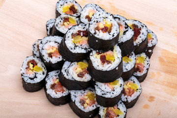 sushi fresh maki rolls isolated on wooden board