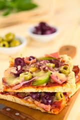 Pizza with tomato sauce, ham, salami, olive, pepper, cheese
