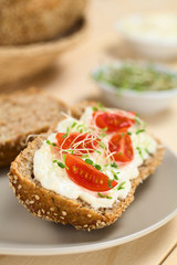 Bread with cream cheese, cherry tomato and alfalfa sprouts