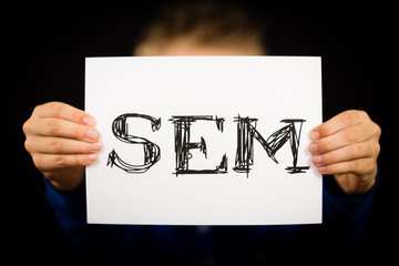 Male holding SEM sign