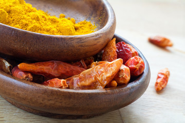Asian spices, dried red chili and curcuma in wooden bowls
