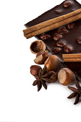 Chocolate and nuts with cinnamon sticks, star anise isolated