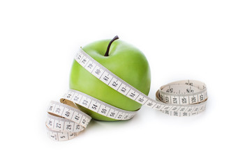 Green apple with measuring tape isolated on white