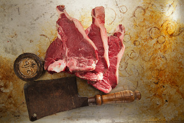beef steak t-bone with vintage butcher cleaver knife