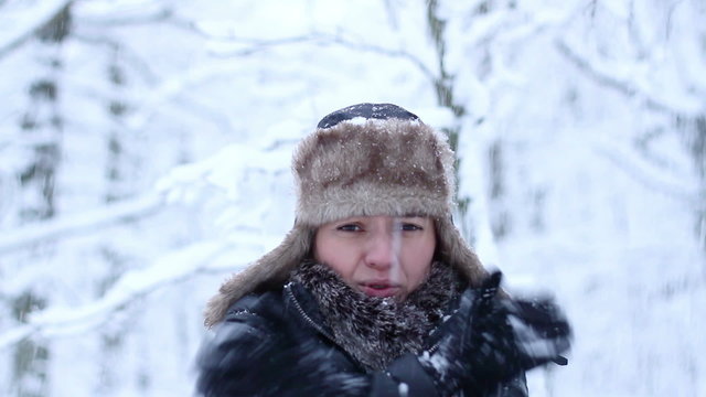 Young woman in winter clothes trying to warm up