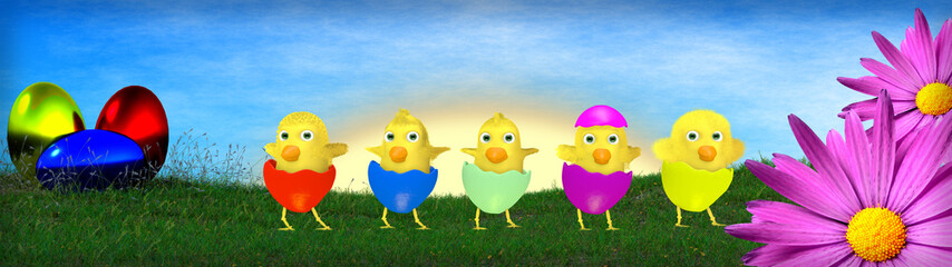 Easter eggs and chickens on green grass