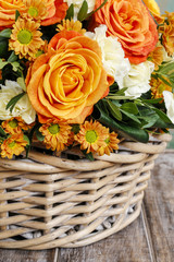 Bouquet of orange roses and ivory carnation flowers