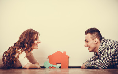 Couple lying on floor daydreaming at home