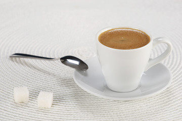 cup of coffee on a white wicker a mat
