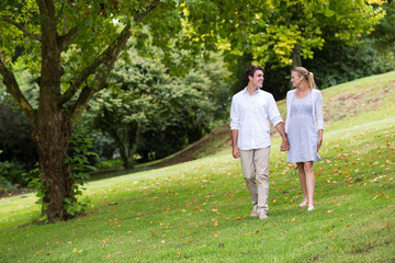 young couple walking at the park