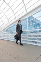 Businessman walking in urban environment of airport or office bu