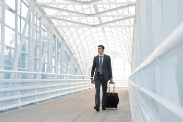 Businessman walking in urban environment of airport