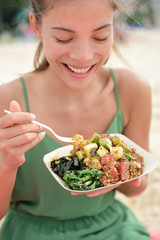 Woman eating local Hawaii food Poke bowl salad