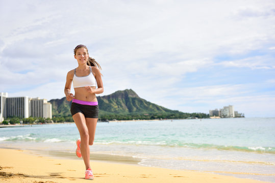 Sport running fitness woman jogging on beach run