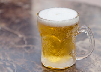 one mug of light beer on the table