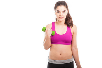 Naklejka premium Young woman lifting weights