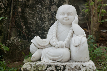 Little Buddha statue made of white stone