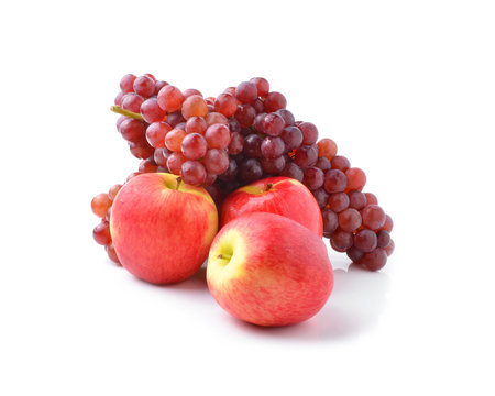 ripe red apples and grapes on white