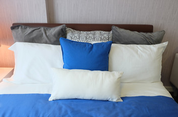 Comfortable soft bed in room with piilows