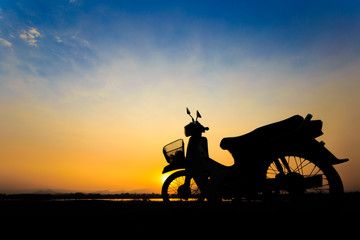 Beautiful landscape image with vintage Motorcycle at sunset