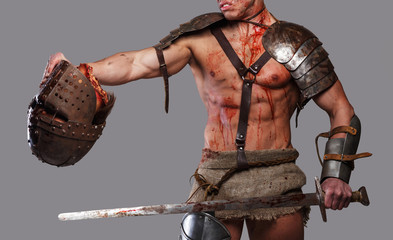 Wounded gladiator with muscular body in armour