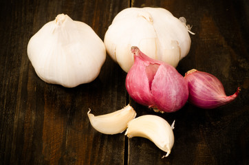 Garlic and shallot on black wooden background