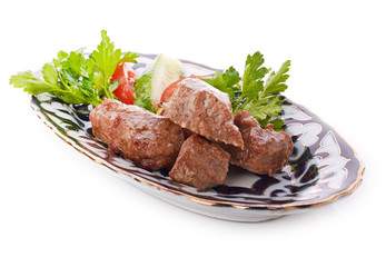 Meat on a grill with vegetables