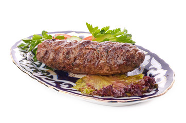 Meat on a grill with vegetables