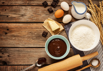 Baking chocolate cake - recipe ingredients on vintage wood